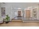 Bright foyer featuring hardwood floors, an open staircase, decorative screen and ample natural light at 55 Dexter St, Denver, CO 80220
