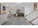 Inviting foyer featuring stylish screen, open staircase and view into the living room with stone fireplace at 55 Dexter St, Denver, CO 80220
