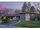Attractive single-story home with a circular driveway, attached garage, and well-maintained lawn and landscape lighting at 55 Dexter St, Denver, CO 80220