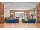 Living area with wood paneling, multiple seating options, and access to outdoor space at 55 Dexter St, Denver, CO 80220