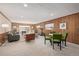 Spacious living room features wood paneled walls, neutral carpet, and ample natural light at 55 Dexter St, Denver, CO 80220