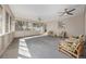 Large sun room features neutral walls, tile floors, wicker furniture and lots of natural light at 55 Dexter St, Denver, CO 80220