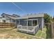 Exterior view of the backyard featuring a deck and an expansive lawn, perfect for outdoor activities at 17692 E Brown Cir, Aurora, CO 80013