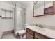 Cozy bathroom featuring a glass shower stall and traditional vanity with ample storage at 17692 E Brown Cir, Aurora, CO 80013