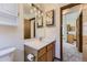 Bright bathroom featuring a single vanity and views to kitchen at 17692 E Brown Cir, Aurora, CO 80013