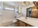 Bathroom with tub and shower combo, white vanity and bright lighting at 17692 E Brown Cir, Aurora, CO 80013