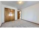 Bright bedroom featuring a double door closet and neutral carpeting at 17692 E Brown Cir, Aurora, CO 80013