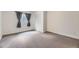 Bedroom with neutral carpeting, gray curtains, and a built in closet at 17692 E Brown Cir, Aurora, CO 80013
