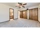 Cozy bedroom featuring a ceiling fan, closet and doorway to bathroom at 17692 E Brown Cir, Aurora, CO 80013
