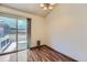 Bright dining area features wood floors, a modern chandelier, and a glass slider to the deck at 17692 E Brown Cir, Aurora, CO 80013