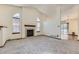 Inviting living room featuring neutral carpet and a cozy tile fireplace at 17692 E Brown Cir, Aurora, CO 80013