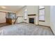 Inviting living room featuring neutral carpet and a cozy tile fireplace at 17692 E Brown Cir, Aurora, CO 80013