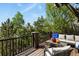 Outdoor deck with a beautiful view of the surrounding trees; has comfortable seating and coffee table at 7243 S Kellerman Way, Aurora, CO 80016