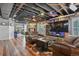 Finished basement boasts wood floors, leather seating, a stone fireplace, and a TV at 7243 S Kellerman Way, Aurora, CO 80016
