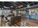Finished basement with leather furniture, wood floors, and a bar at 7243 S Kellerman Way, Aurora, CO 80016
