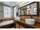 Elegant bathroom features double sinks, granite countertops, stone accents, and a soaking tub at 7243 S Kellerman Way, Aurora, CO 80016