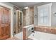 Spa-like bathroom featuring tiled shower, soaking tub, and wood accents at 7243 S Kellerman Way, Aurora, CO 80016