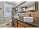 Bright bathroom with dual vessel sinks, granite counters, wood cabinets, and stylish fixtures at 7243 S Kellerman Way, Aurora, CO 80016