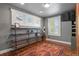 Bright bedroom with custom wood shelving, hardwood floors and three large windows at 7243 S Kellerman Way, Aurora, CO 80016