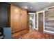 Bedroom features a Murphy bed, wood-paneled wall, hardwood floors, and a stylish area rug at 7243 S Kellerman Way, Aurora, CO 80016