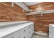 Custom closet with white cabinets and wood paneled walls at 7243 S Kellerman Way, Aurora, CO 80016