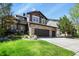 Charming two-story home featuring a stone facade and a spacious three-car garage at 7243 S Kellerman Way, Aurora, CO 80016