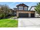 Charming two-story home featuring a stone facade and a spacious three-car garage at 7243 S Kellerman Way, Aurora, CO 80016