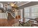 Elegant foyer with hardwood floors, staircase, and natural light from the windows at 7243 S Kellerman Way, Aurora, CO 80016