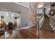 Elegant foyer showcasing a stone accent wall and staircase to upper level at 7243 S Kellerman Way, Aurora, CO 80016