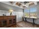 Bright office space with wood floors, custom trim work, and abundant natural light from the large window at 7243 S Kellerman Way, Aurora, CO 80016