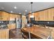 Bright kitchen featuring wood cabinetry, stainless steel appliances, and slate flooring at 7243 S Kellerman Way, Aurora, CO 80016