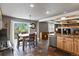 Bright eat-in kitchen with slate floors, wood cabinets, stainless appliances, and access to outdoor space at 7243 S Kellerman Way, Aurora, CO 80016