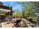 Outdoor space featuring a fire pit, seating area, fountain, and views of trees and the back of the home at 7243 S Kellerman Way, Aurora, CO 80016