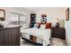This charming bedroom has a comfortable bed, dresser, and a well-lit window, creating an inviting space at 5676 Emporia St, Denver, CO 80238