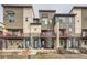 Modern townhome exterior showcasing a stylish facade, private balconies, and well-maintained landscaping at 5676 Emporia St, Denver, CO 80238