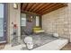 Cozy front porch features modern furnishings, a hanging swing, and decorative accents for relaxing outdoors at 5676 Emporia St, Denver, CO 80238