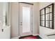 Entryway with a frosted glass door, dark floors, and window, combining privacy with natural light at 5676 Emporia St, Denver, CO 80238