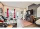 Comfortable living room with hardwood floors, a stylish entertainment center, and abundant natural light at 5676 Emporia St, Denver, CO 80238