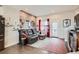 Charming living room featuring a brick accent wall, comfortable seating, and access to a balcony at 5676 Emporia St, Denver, CO 80238