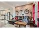 Open-concept living space showcasing a brick wall, hardwood floors, and seamless flow to the kitchen at 5676 Emporia St, Denver, CO 80238