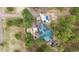 Birds eye view of the home, showing the rooftop solar panels, the outdoor pool and lush landscaping at 7317 Fremont Pl, Larkspur, CO 80118