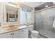 Well-lit bathroom featuring a shower and tiled flooring at 7317 Fremont Pl, Larkspur, CO 80118