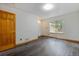 Bedroom with hardwood floors, light walls, and a large window view at 7317 Fremont Pl, Larkspur, CO 80118