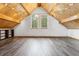 Bonus room with wood-beam ceilings, wood floors, and natural light at 7317 Fremont Pl, Larkspur, CO 80118
