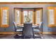 Charming dining area featuring a round table, shuttered windows, wood trim and stylish decor at 7317 Fremont Pl, Larkspur, CO 80118