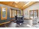 Cozy dining area with a round table, shuttered windows, and a wood plank ceiling with skylight at 7317 Fremont Pl, Larkspur, CO 80118