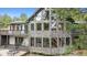Striking stone house featuring many windows, a deck, and a covered porch with outdoor seating at 7317 Fremont Pl, Larkspur, CO 80118