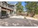 Exterior of house with stone facade, walkout patio, with outdoor seating at 7317 Fremont Pl, Larkspur, CO 80118