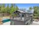 Exterior of home featuring a deck with pergola and solar panels at 7317 Fremont Pl, Larkspur, CO 80118