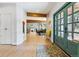 Spacious foyer featuring beautiful flooring, wood beams, and an open view into the dining area and living room at 7317 Fremont Pl, Larkspur, CO 80118